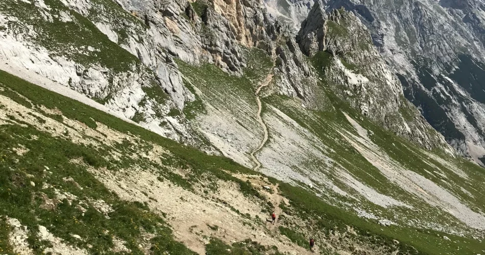 Alpine landscape with a path on a slope