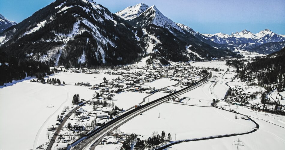 A drone shot of the village of Bichlbach in winter