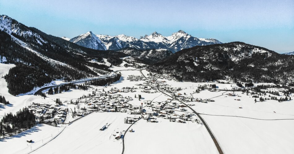 A drone shot of the village of Heiterwang am See in winter