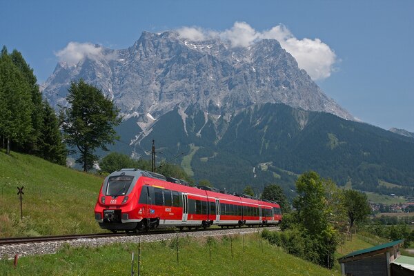 Red train in front of the Zugspitze