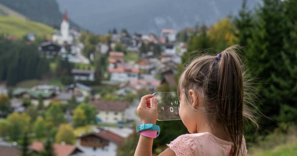 A girl looks at a transparent puzzle object