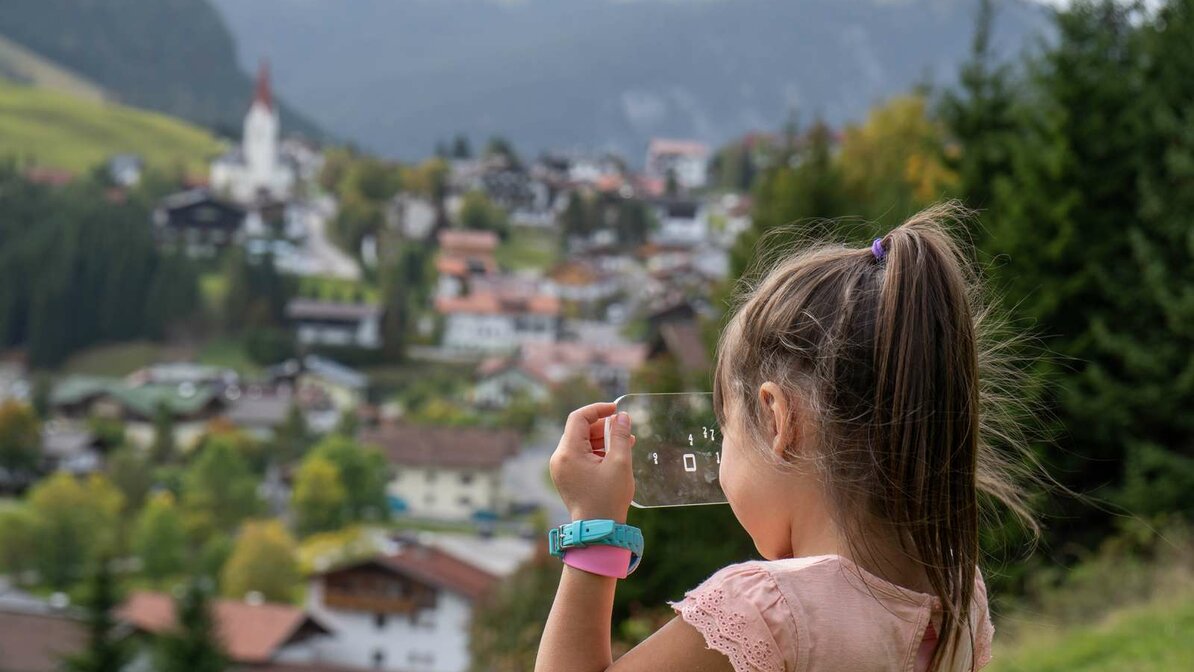 A girl looks at a transparent puzzle object