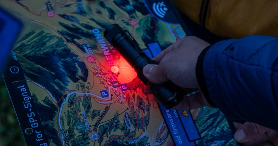 A map is illuminated with a red light 