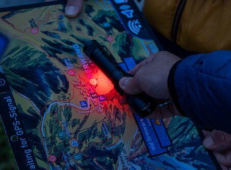 A map is illuminated with a red light 