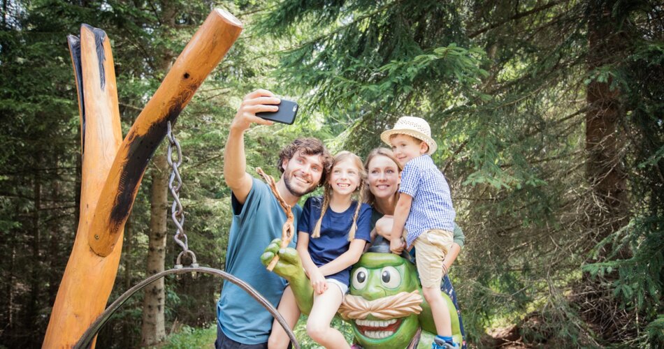 Eine Familie macht ein Foto mit einer frosch-ähnlichen Figur | © Tiroler Zugspitz Arena/C. Jorda