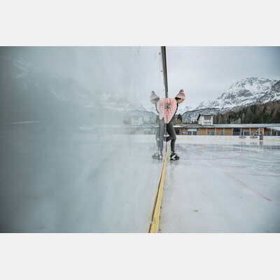 Woman stepping onto outdoor ice rink. | © Tiroler Zugspitz Arena/C. Jorda