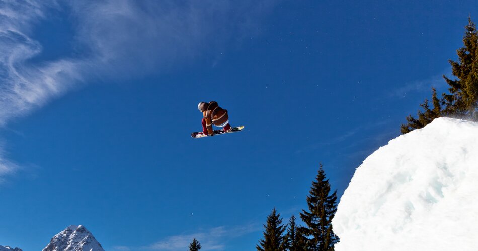 A  snowboarder doing a jump