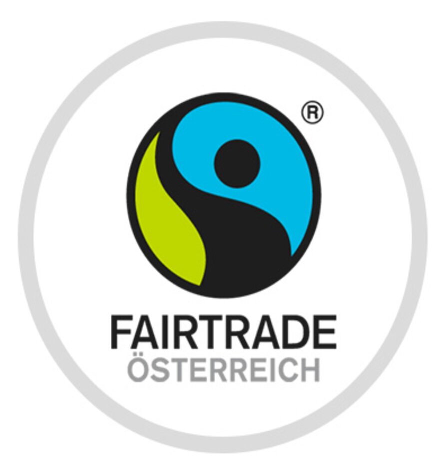 A blue, black and green circle and the inscription Fairtrade Österreich | © Fairtrade Österreich