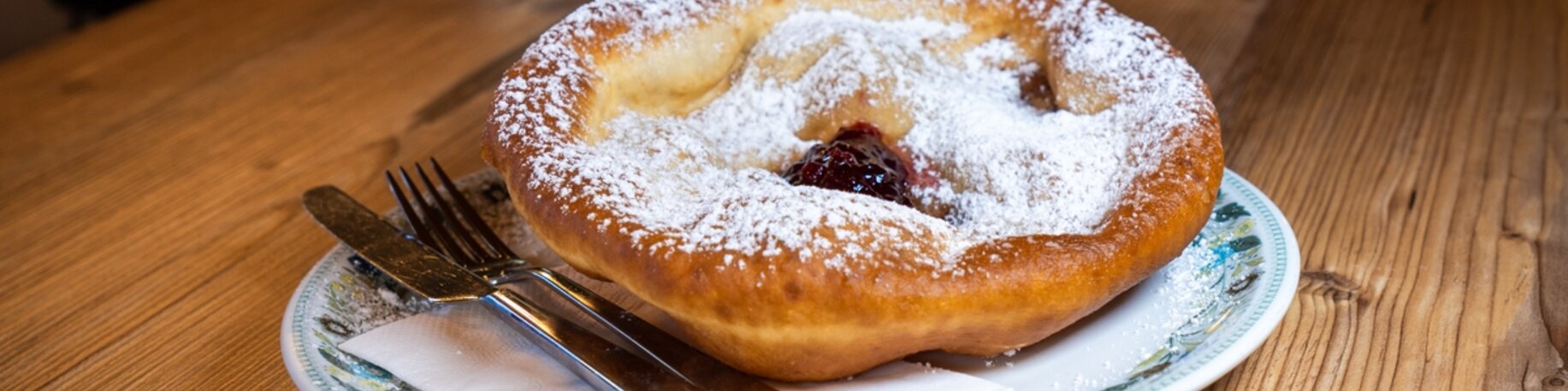 A Tyrolean specialty, fried dough pancake, traditionally with powdered sugar and cranberries or with sauerkraut. 