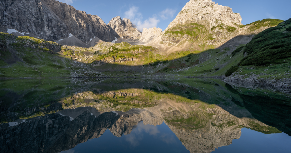 the mountains are reflected in the water of a lake
